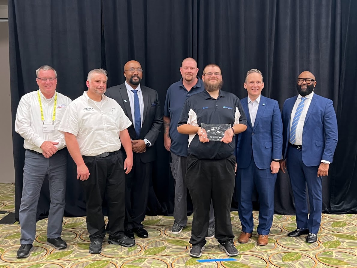 PSTA technician Derrick N. Brown holding his award for 2nd place Bus Technician of the Year with other leaders