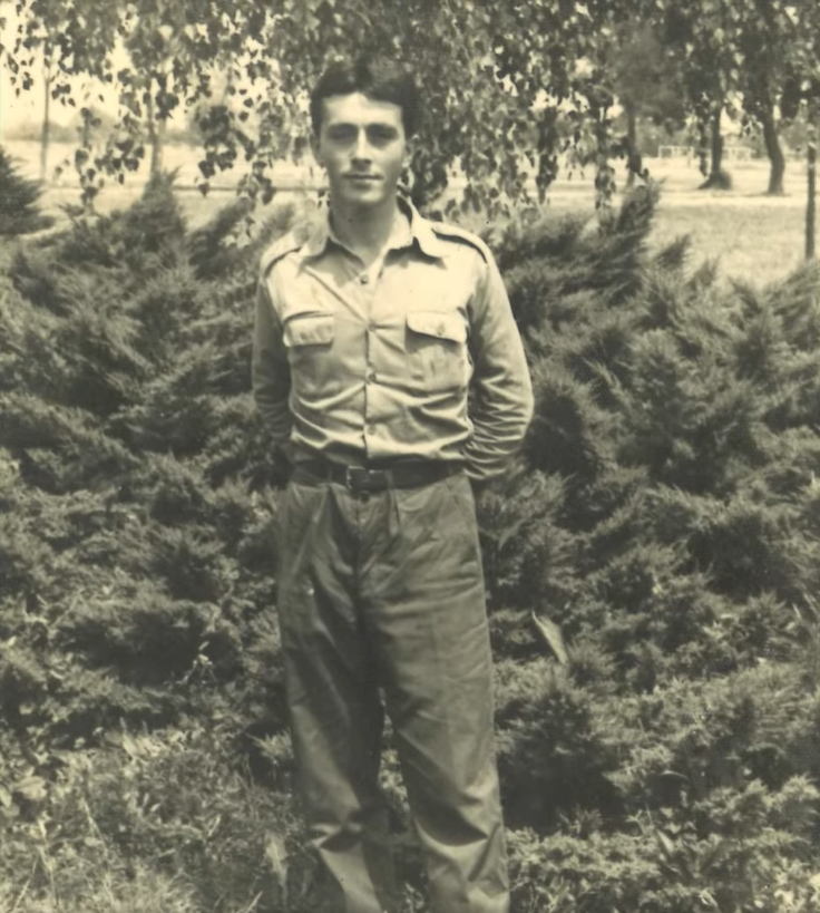 A black and white photo of Milan as a young adult, dressed in a bus driver uniform in former Yugoslavia.